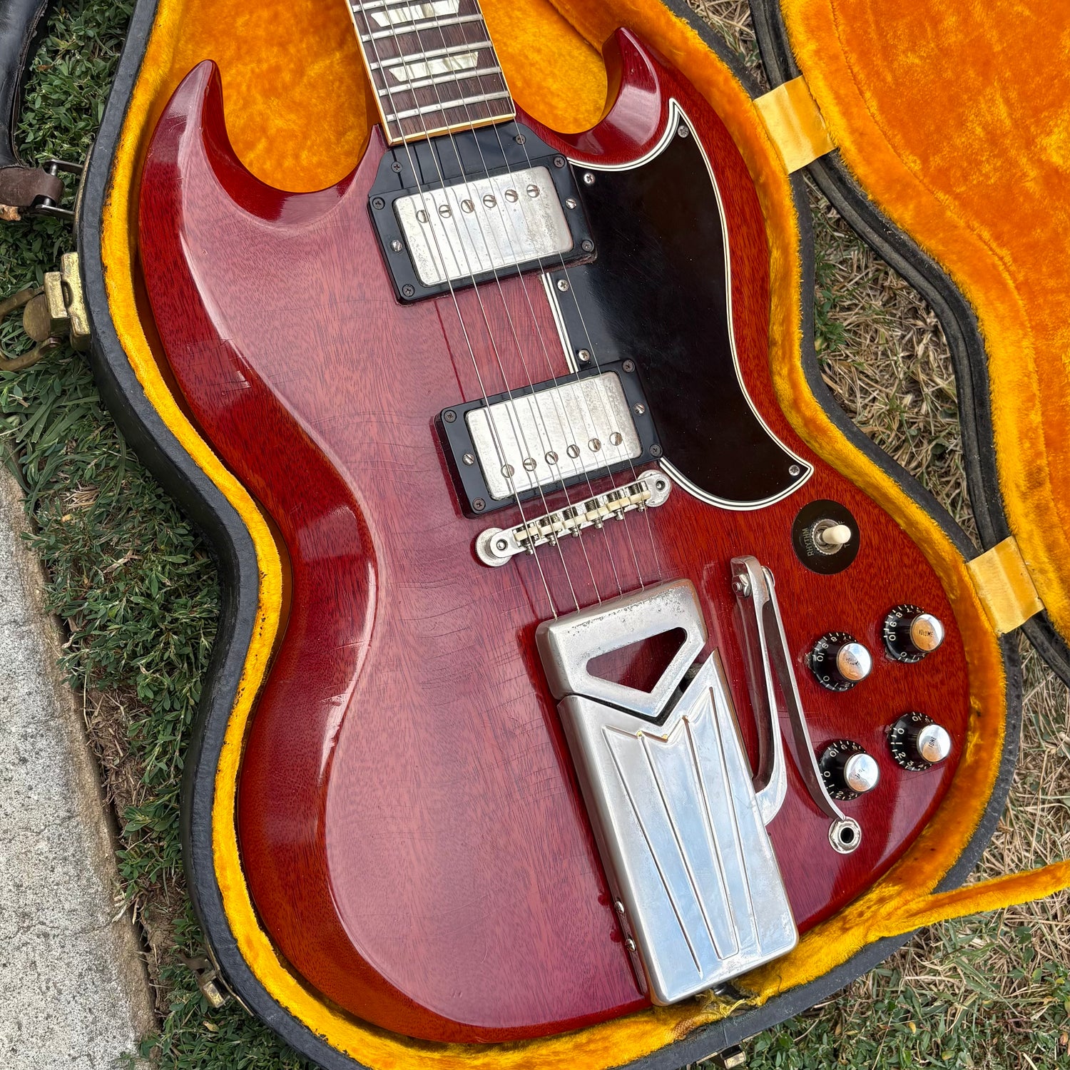 1962 Les Paul Standard with Patent Applied For humbucking pickups in yellow case laying on ground