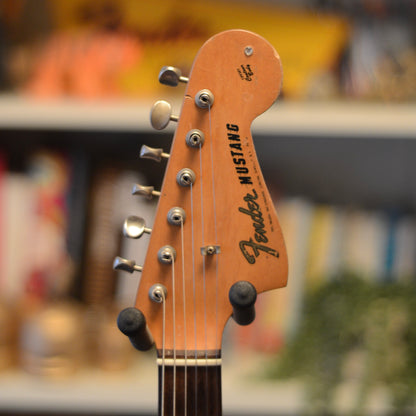Pre-CBS Fender Mustang guitar headstock with blurred background