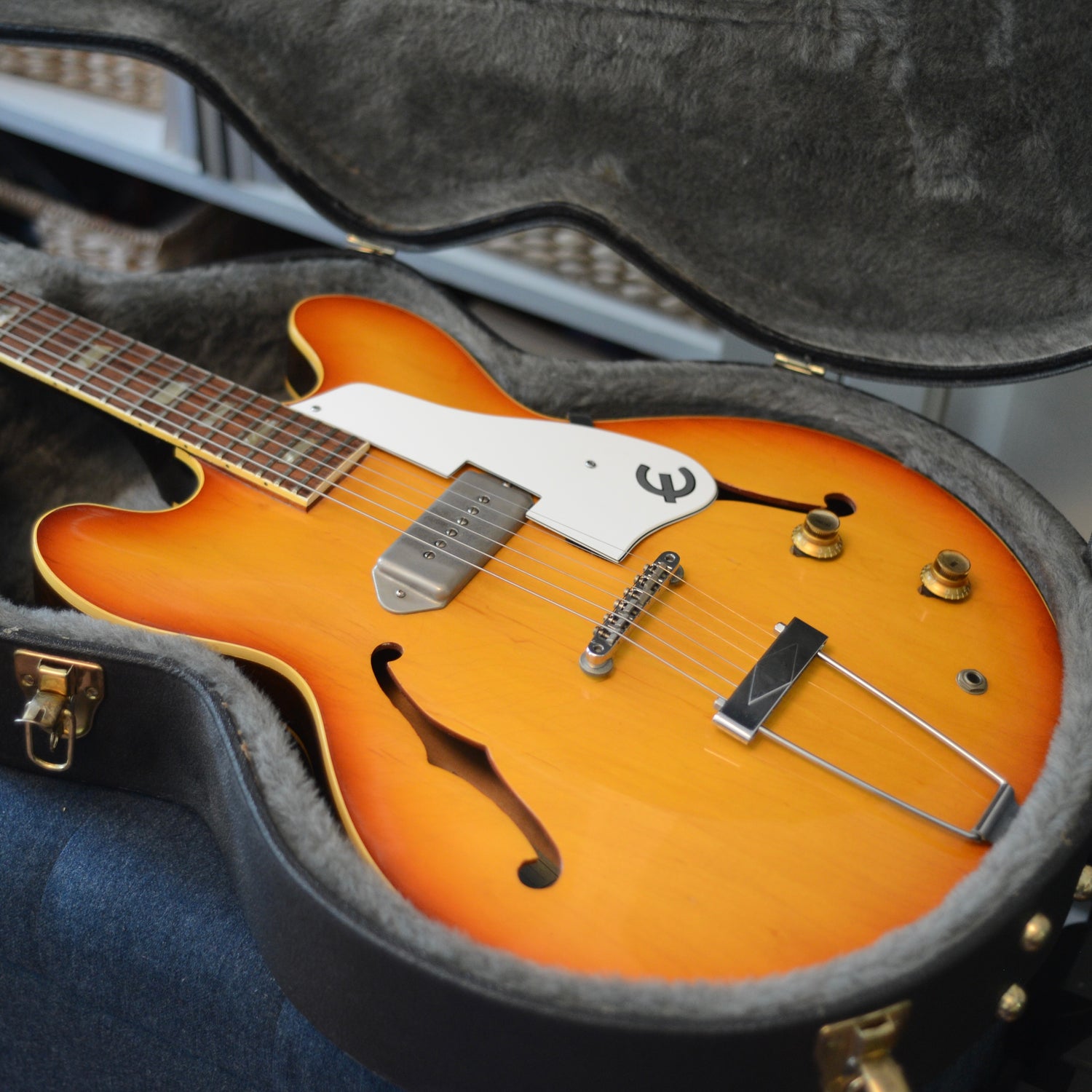 Sunburst hollow body electric guitar in a black case