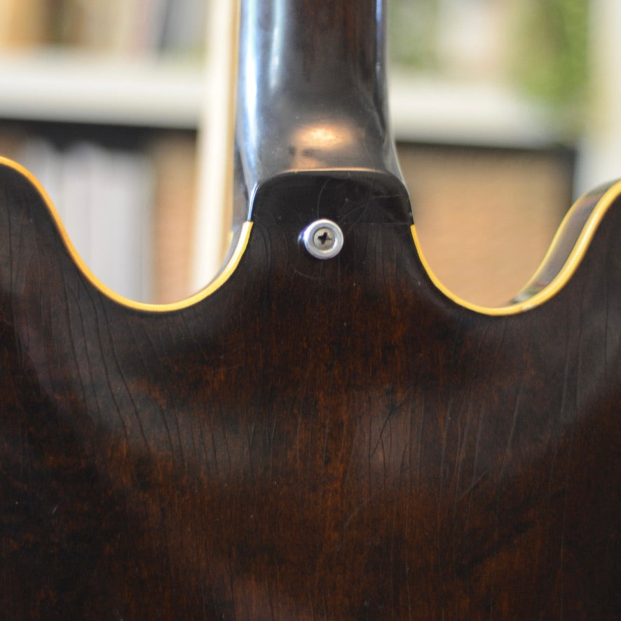 Photo zoomed in at the neck joint of Epiphone Riviera, shows no breaks or repairs and an added period correct strap button