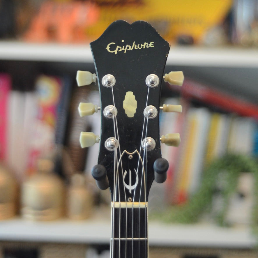Shows the front of the headstock of guitar